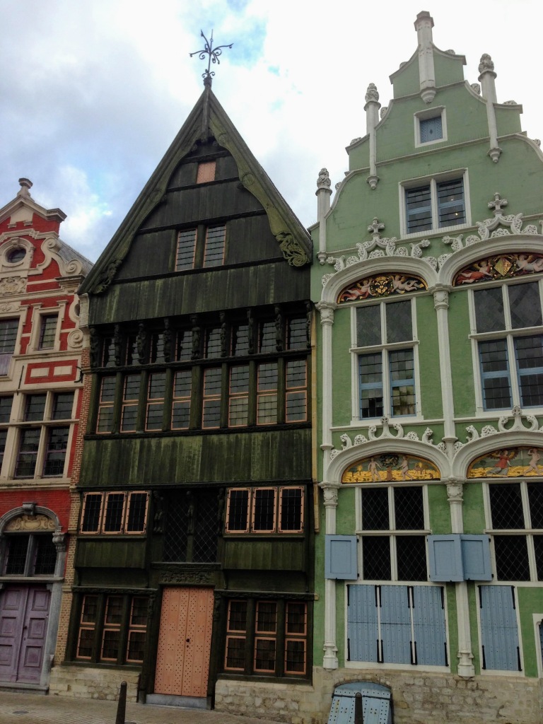 Three colorful houses in green, red, and black in Mechelen Belgium